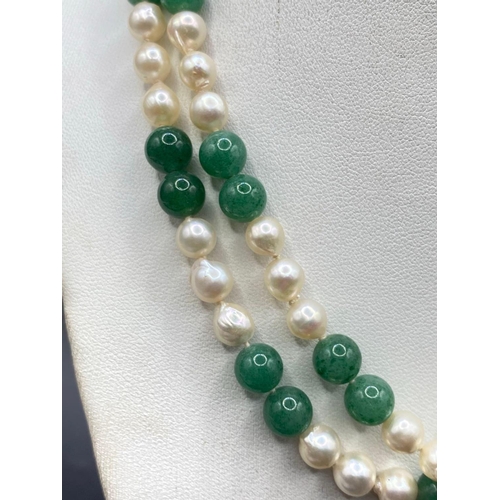 364 - A LONG PEARL AND JADE NECKLACE WITH 14CT GOLD CLASP 34 INCH