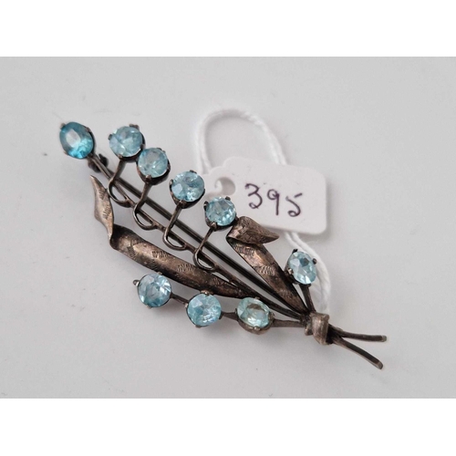 395 - A silver and blue zircon brooch