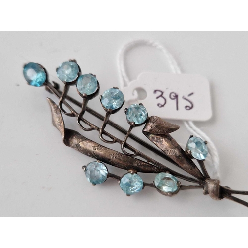 395 - A silver and blue zircon brooch