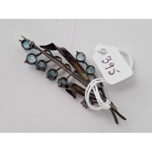 395 - A silver and blue zircon brooch