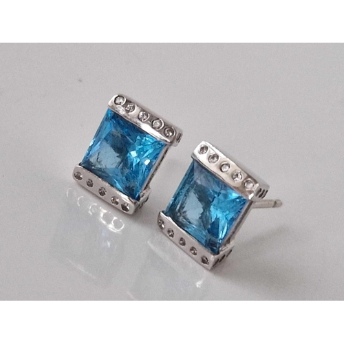 475 - A pair of white gold blue topaz ear studs 14ct gold 3.5 gms