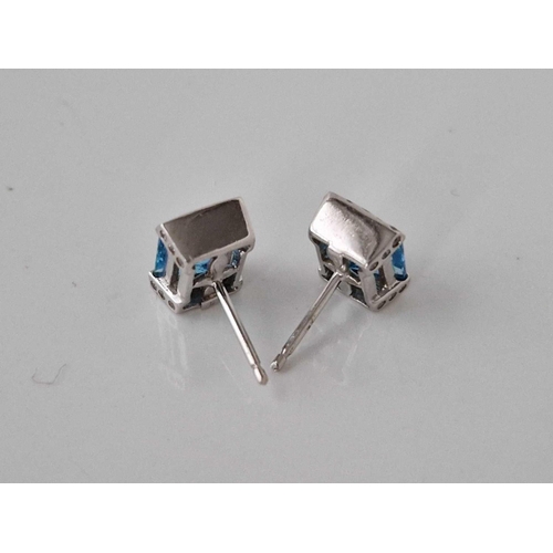 475 - A pair of white gold blue topaz ear studs 14ct gold 3.5 gms