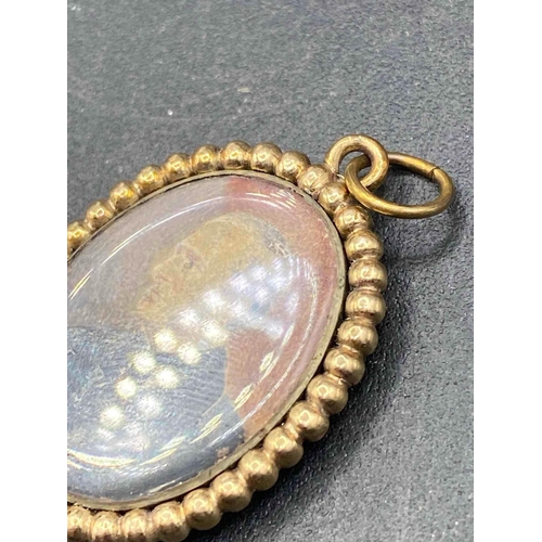 48 - A Victorian glazed pendant tubular frame inset hand painted miniature of a aristocrat 18ct gold