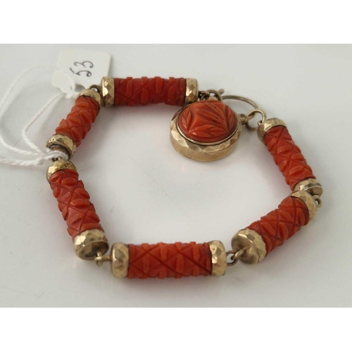 53 - A VICTORIAN CARVED CORAL AND GOLD BRACELET WITH PADLOCK CLASP 7 INCH BOXED