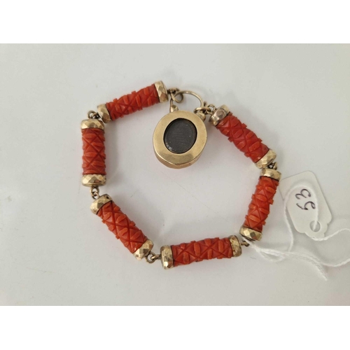 53 - A VICTORIAN CARVED CORAL AND GOLD BRACELET WITH PADLOCK CLASP 7 INCH BOXED