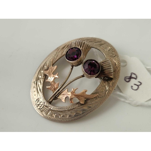 83 - A silver and 9ct thistle brooch