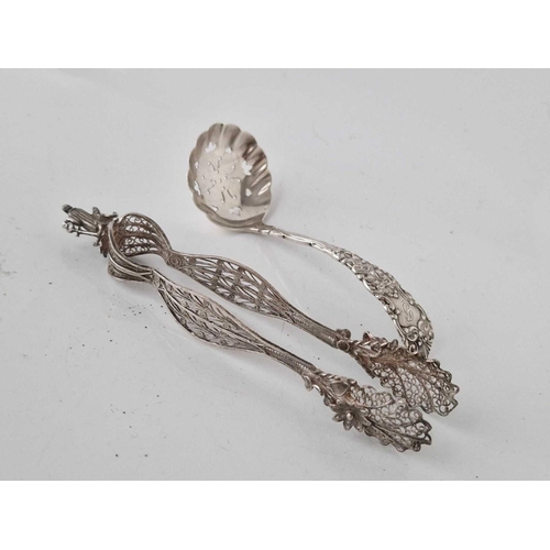 889 - A pair of decorative filigree sugar tongs and a small sifter spoon, Birmingham 1899