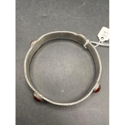 119 - A large silver and carnelian set bangle