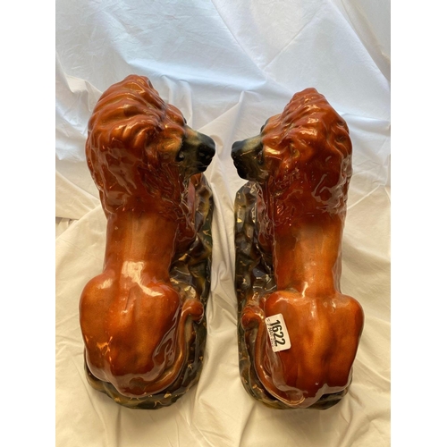 1622 - A pair of Staffordshire lions 13 inches long