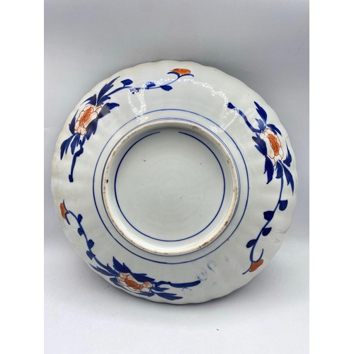 1624 - A Imari plate with decorated panels 13 inches diameter