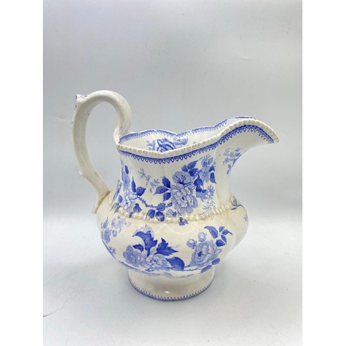 1625 - A 19th century blue and white jug painted with flowers 9 inches high