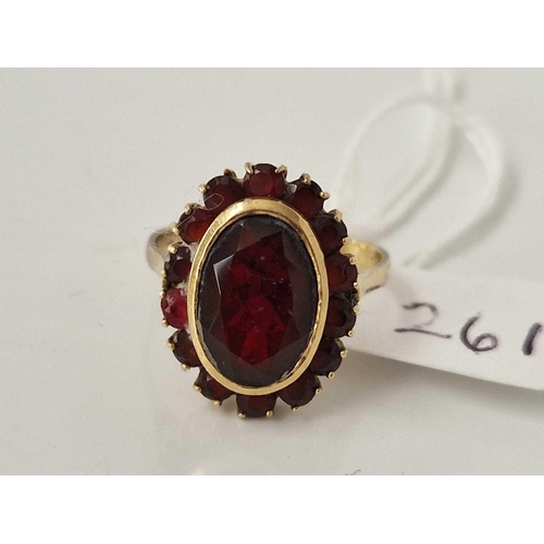 261 - A GARNET CLUSTER RING 18CT GOLD SIZE N 5.3 GMS