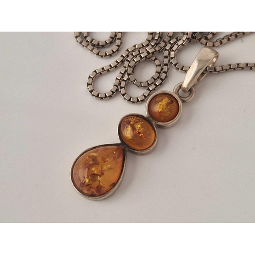 275 - A amber pendant necklace 23 inch and set of matching earrings