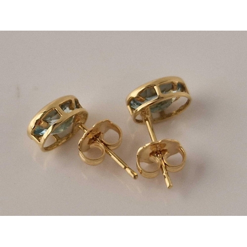 302 - A pair of aquamarine set earrings 18ct gold 7.5 X 6mm