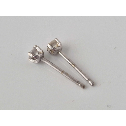 312 - A pair of diamond solitaire earrings