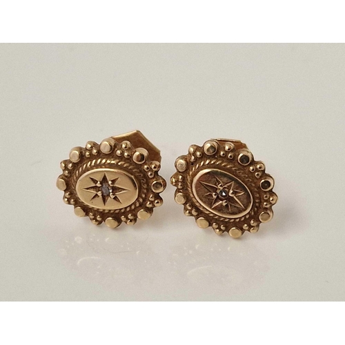 398 - A pair of oval earrings with small diamonds set in gold 1.9 gms