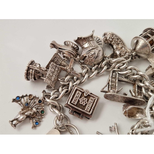 413 - A silver charm bracelet 7 inch 108 gms