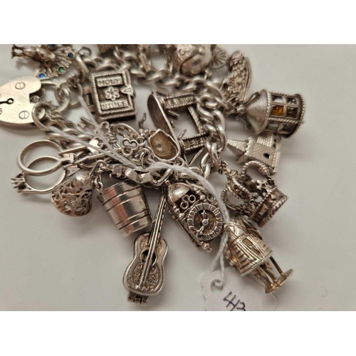 413 - A silver charm bracelet 7 inch 108 gms