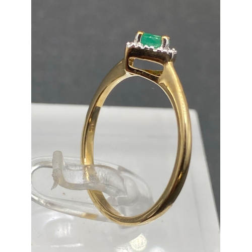 463 - A pretty emerald and diamond dress ring 9ct size P