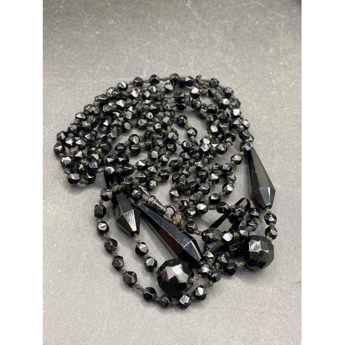 467 - A vintage memorial jet fancy opera length guard chain with original matched swivel 175 cm