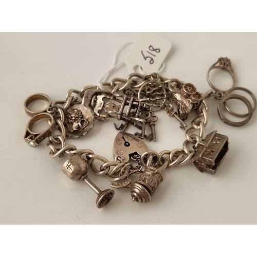 518 - A silver charm bracelet 7 inch 38 gms