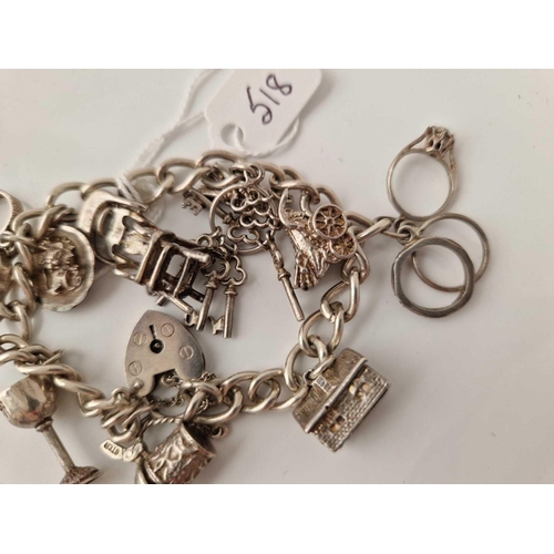 518 - A silver charm bracelet 7 inch 38 gms