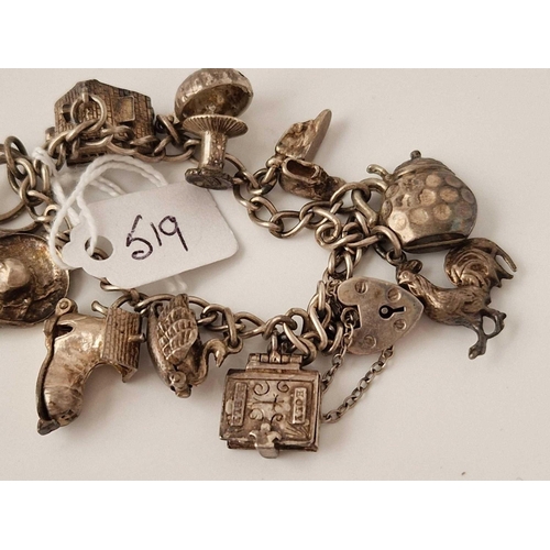 519 - A silver charm bracelet 7 inch 34 gms