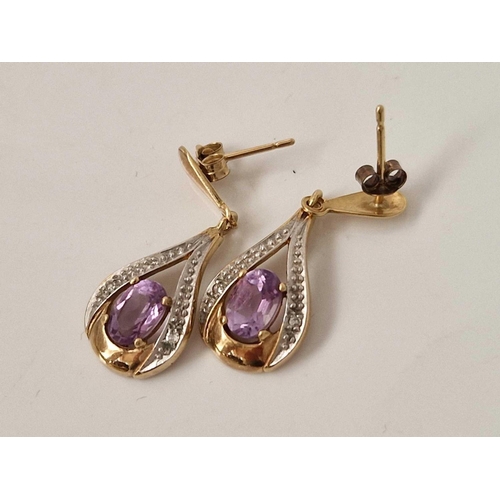 555 - A pair of amethyst and diamond earrings 9ct 1.9 gms