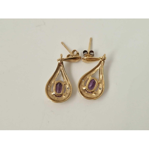 555 - A pair of amethyst and diamond earrings 9ct 1.9 gms