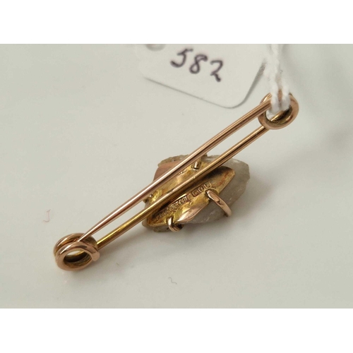 582 - A gold mounted Miners brooch with gold and quartz nugget