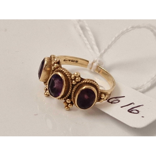 616 - A three stone amethyst ring 9ct size M 3.4 gms