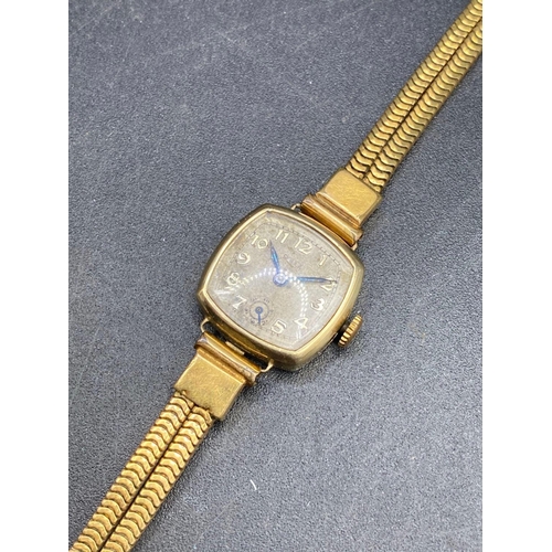 658 - A ladies ROLEX wrist watch 9ct with metal strap