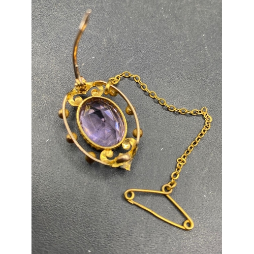 69 - A Victorian amethyst and pearl brooch with gold safety chain