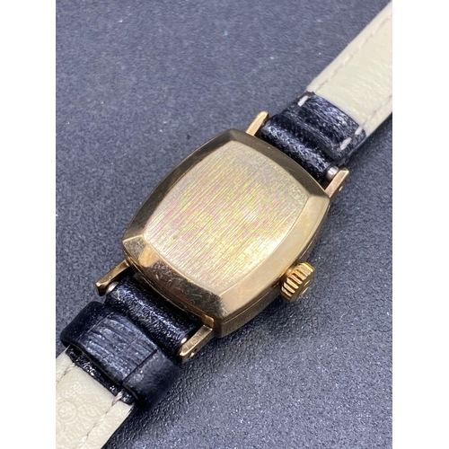 700 - A ladies OMEGA wrist watch 9ct with black leather strap