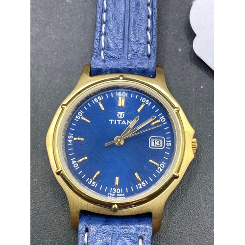 711 - A TITAN wrist watch with blue dial and strap