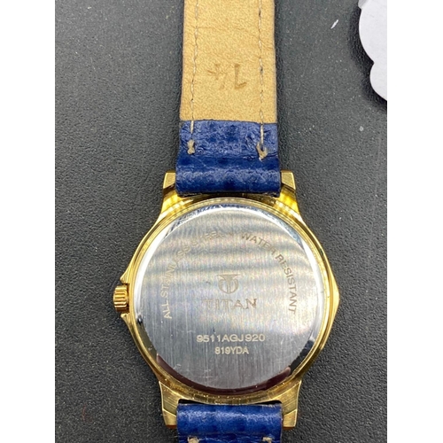 711 - A TITAN wrist watch with blue dial and strap