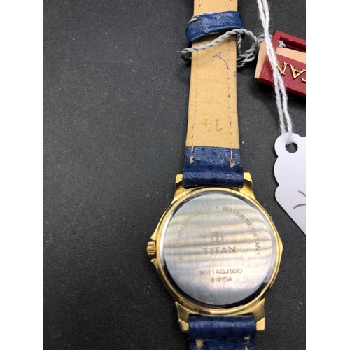 711 - A TITAN wrist watch with blue dial and strap