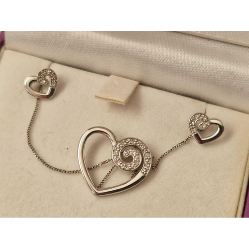 79 - A white gold diamond heart pendant and matching earrings 9ct boxed