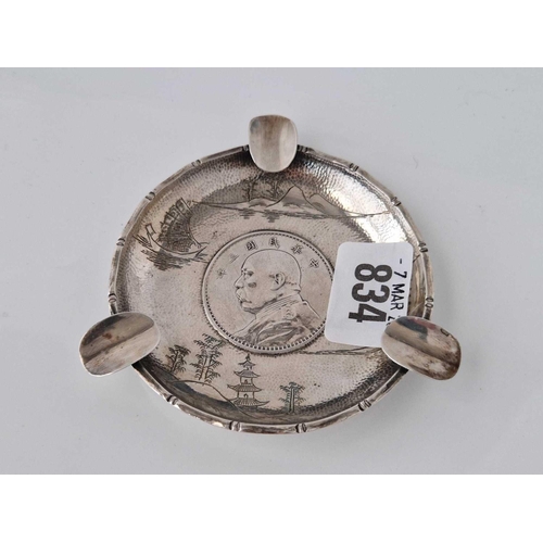 834 - A Chinese coin set ashtray with engraved mounts, 4 inches diameter, 63 g.