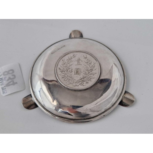 834 - A Chinese coin set ashtray with engraved mounts, 4 inches diameter, 63 g.