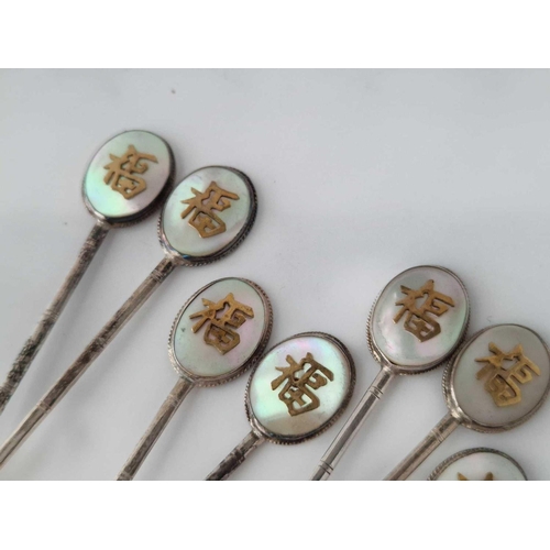 849 - A set of eight Chinese and MOP decorated topped spoons, stamped sterling, 61 g.