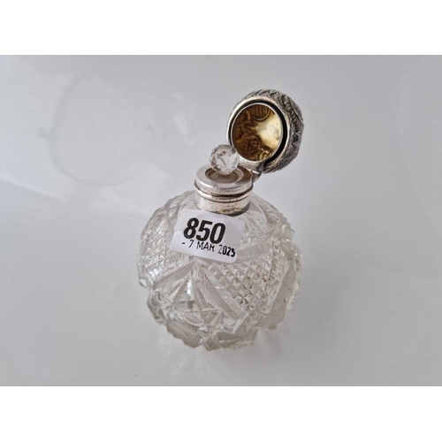 850 - An Edwardian silver topped scent bottle with embossed cover and a stopper, 4 inches high, Birmingham... 