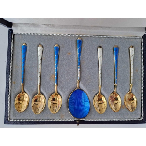 851 - A boxed set of Danish silver gilt and enamel spoons, stamped sterling by ELA?