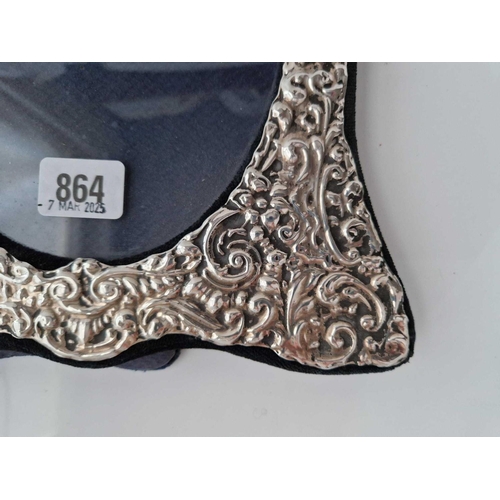 864 - A Large oval photo frame with embossed decoration, 12.5