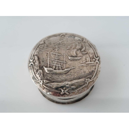 878 - A circular Dutch box with hinged cover, lightly embossed with a Marine scene, 1.5