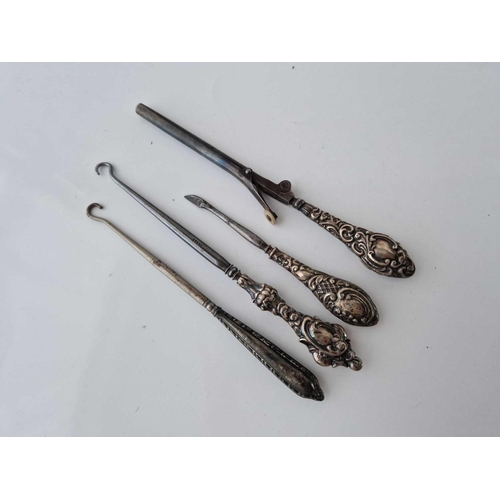 926 - Four silver handled button hooks etc