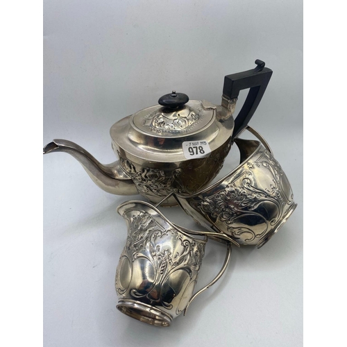 978 - An Art Nouveau style embossed teaset on rim foot, Sheffield 1901 by JB WB, 975 g.