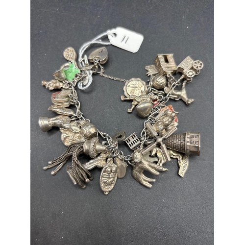 11 - A silver charm bracelet 95 gms