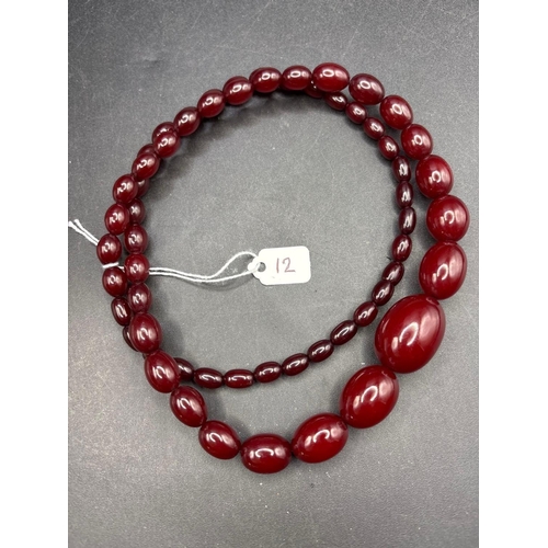 12 - A string of cherry amber beads 61.3 gms