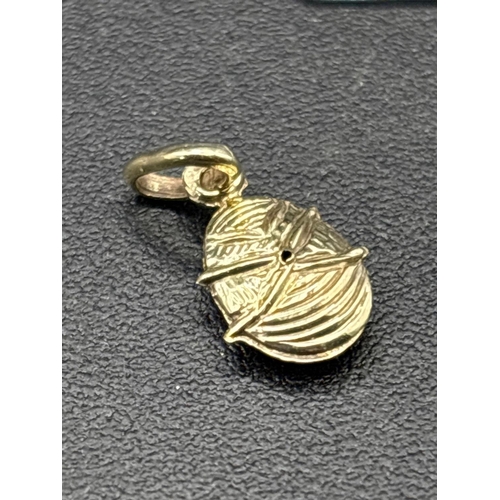 56 - A novelty high carat gold and enamel ladybird pendant